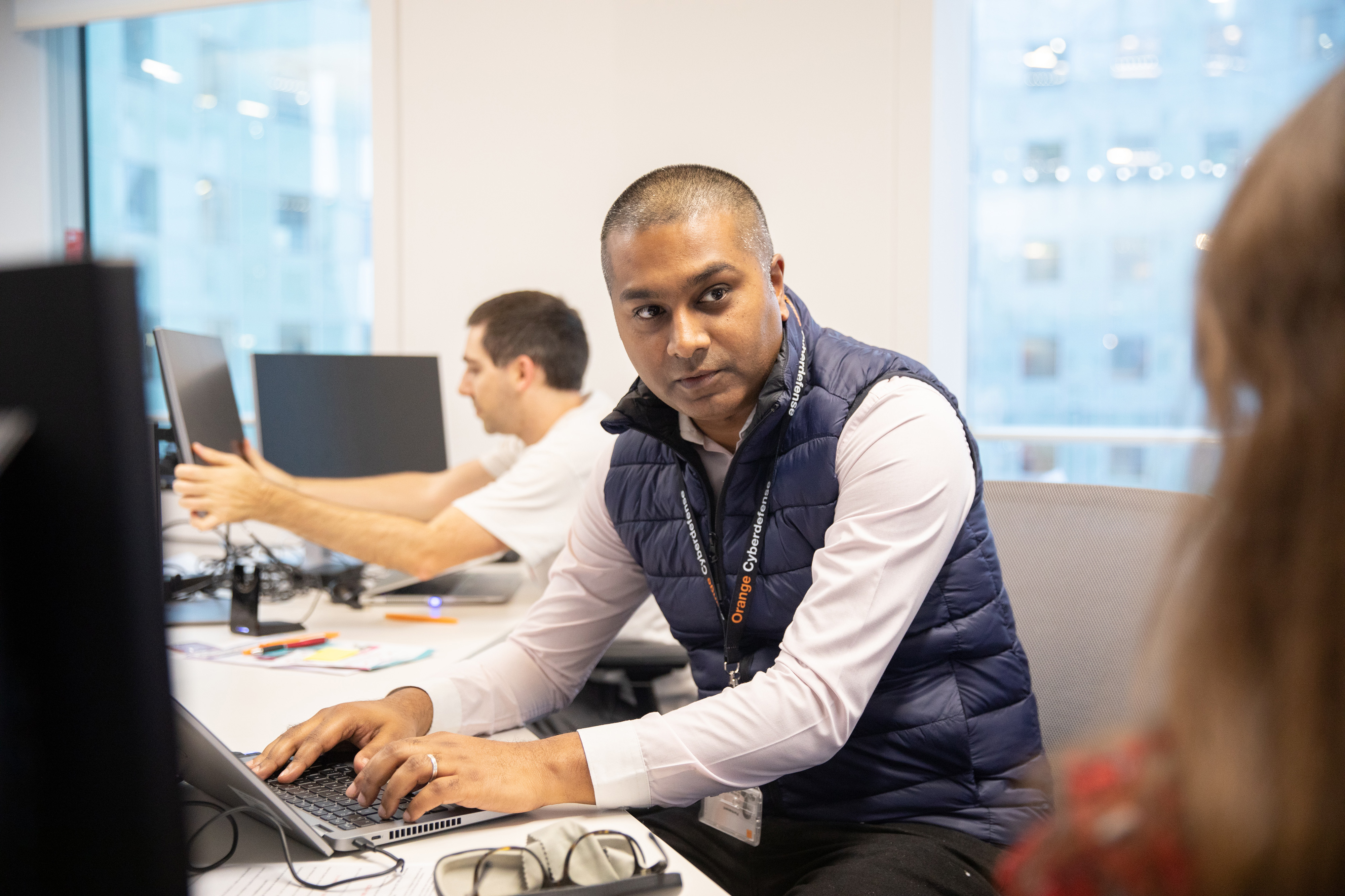 An Orange employee working in the office