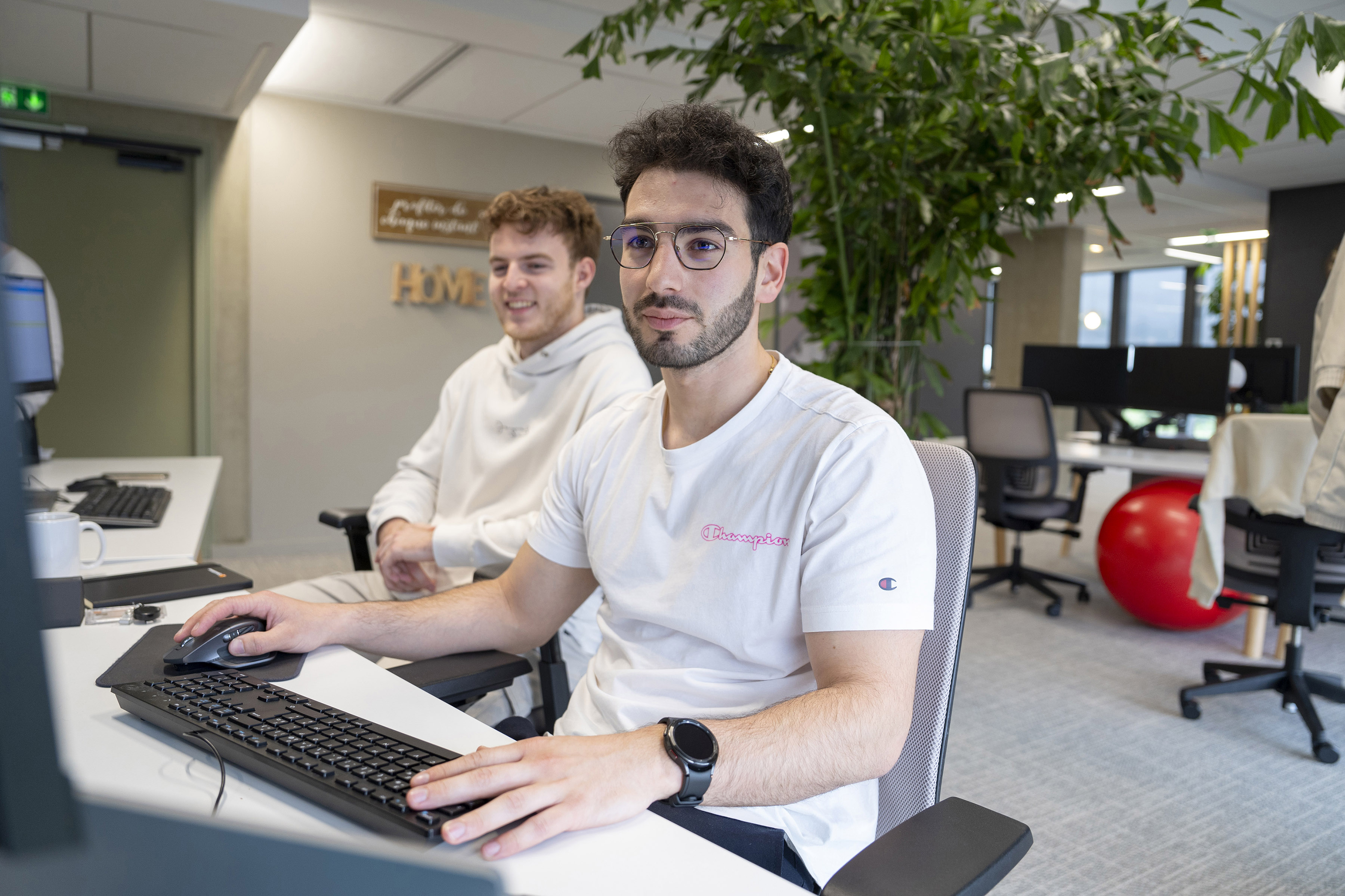 Two Orange employees working on a computer
