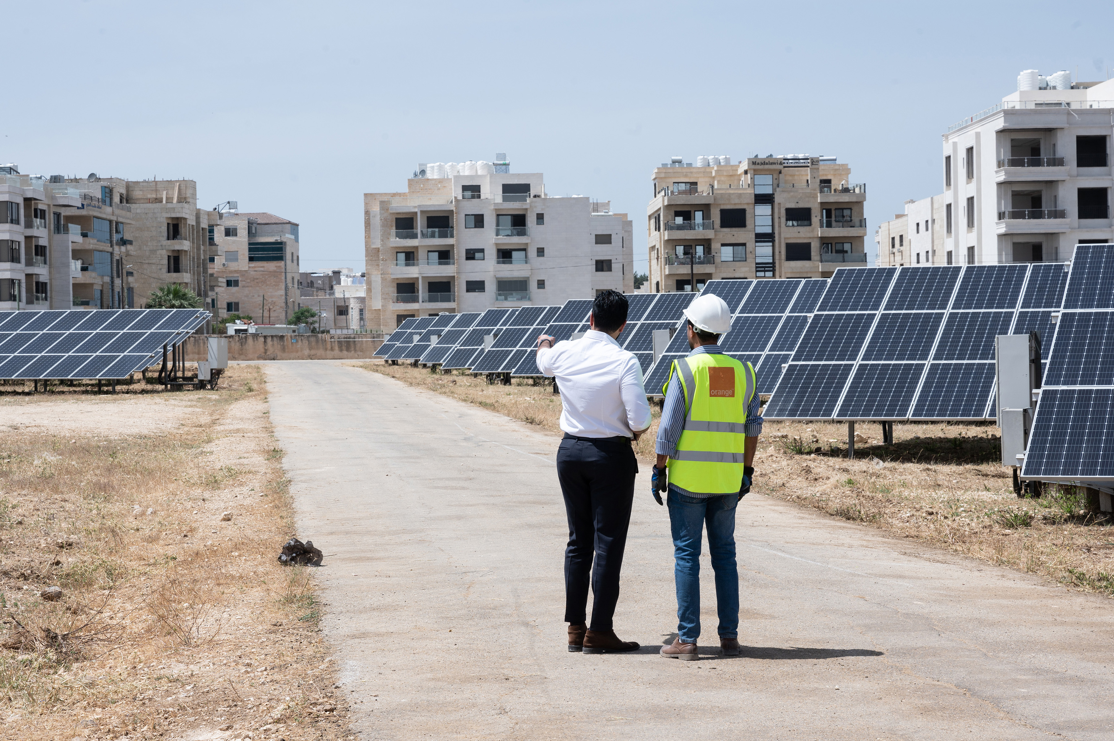 Orange employees working together on a project