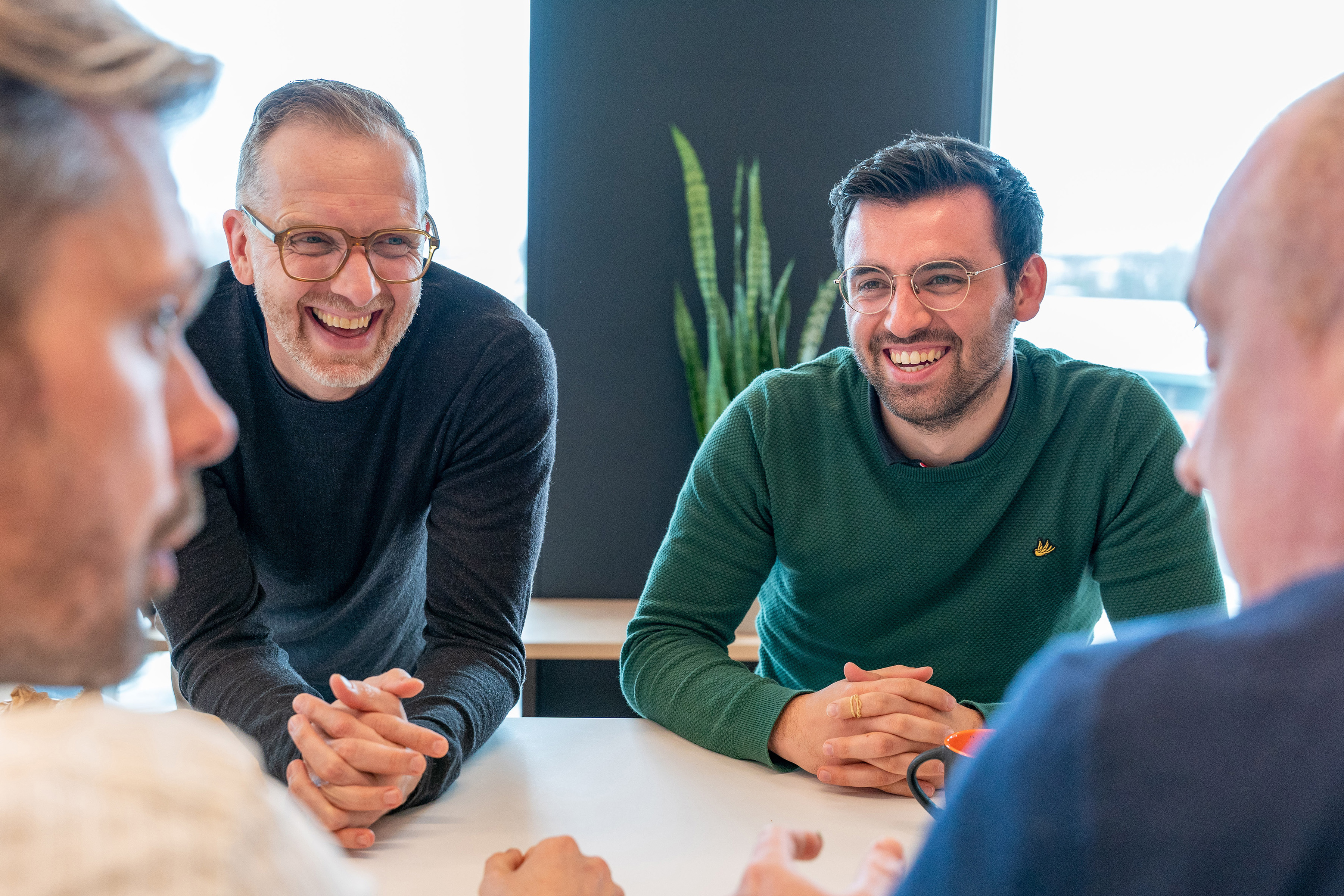 Orange employees discussing in a meeting