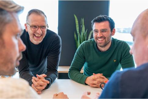 Orange employees discussing in a meeting