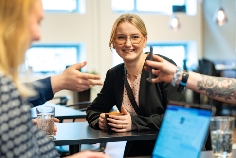 Smiling Orange colleague in a meeting