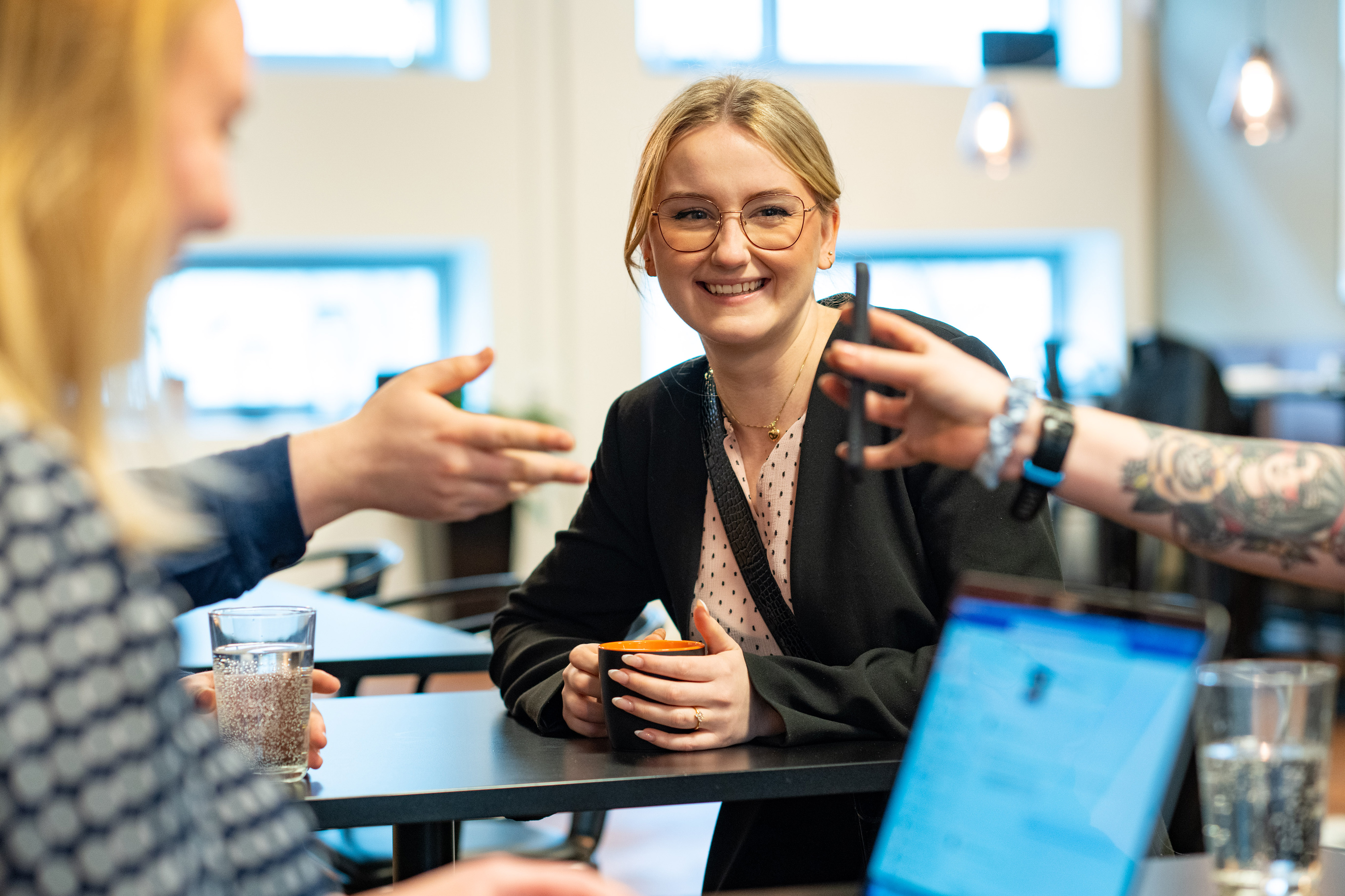 Smiling Orange colleague in a meeting