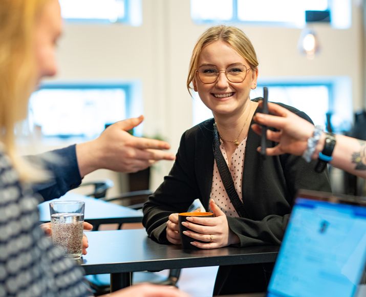 Smiling Orange colleague in a meeting