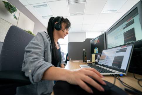 Orange employee providing customer support with headset
