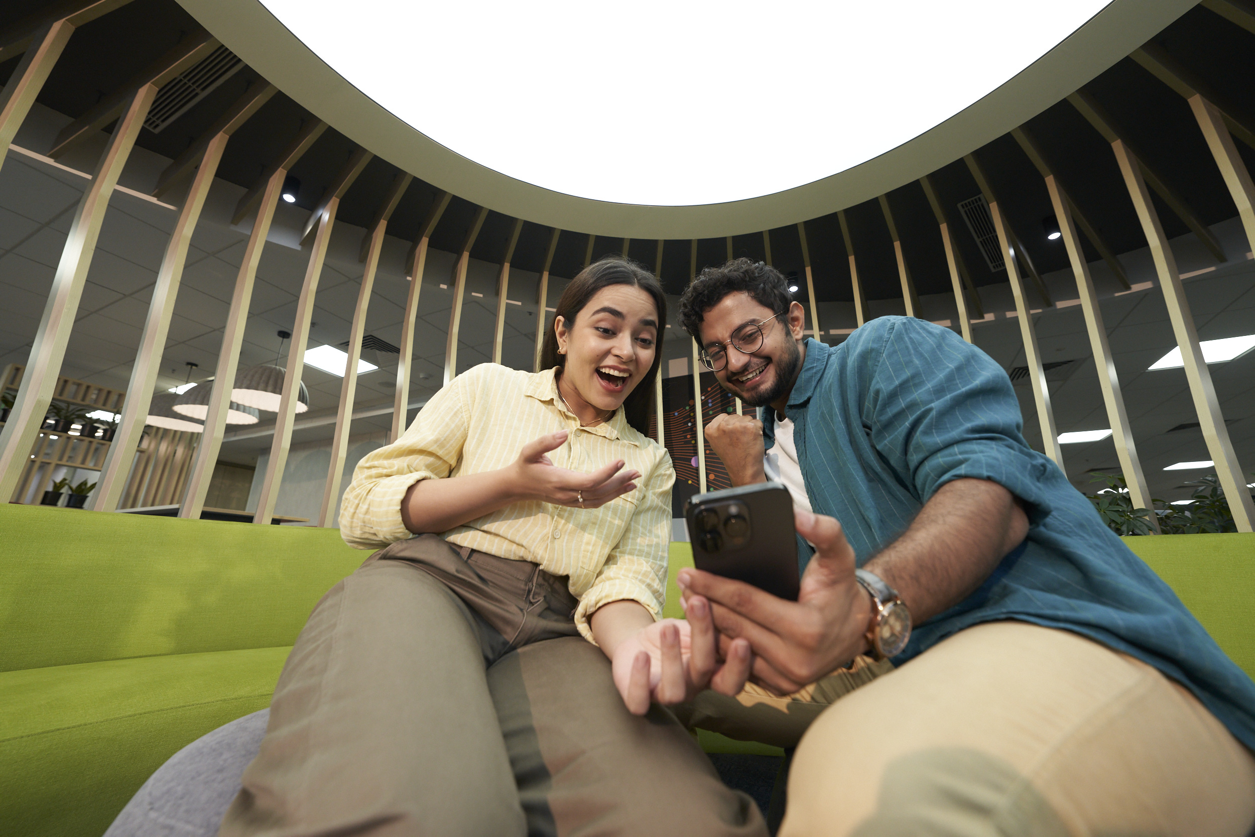 Three Orange colleagues discussing in an office space