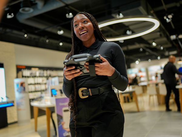 Orange advisor using tablet in store