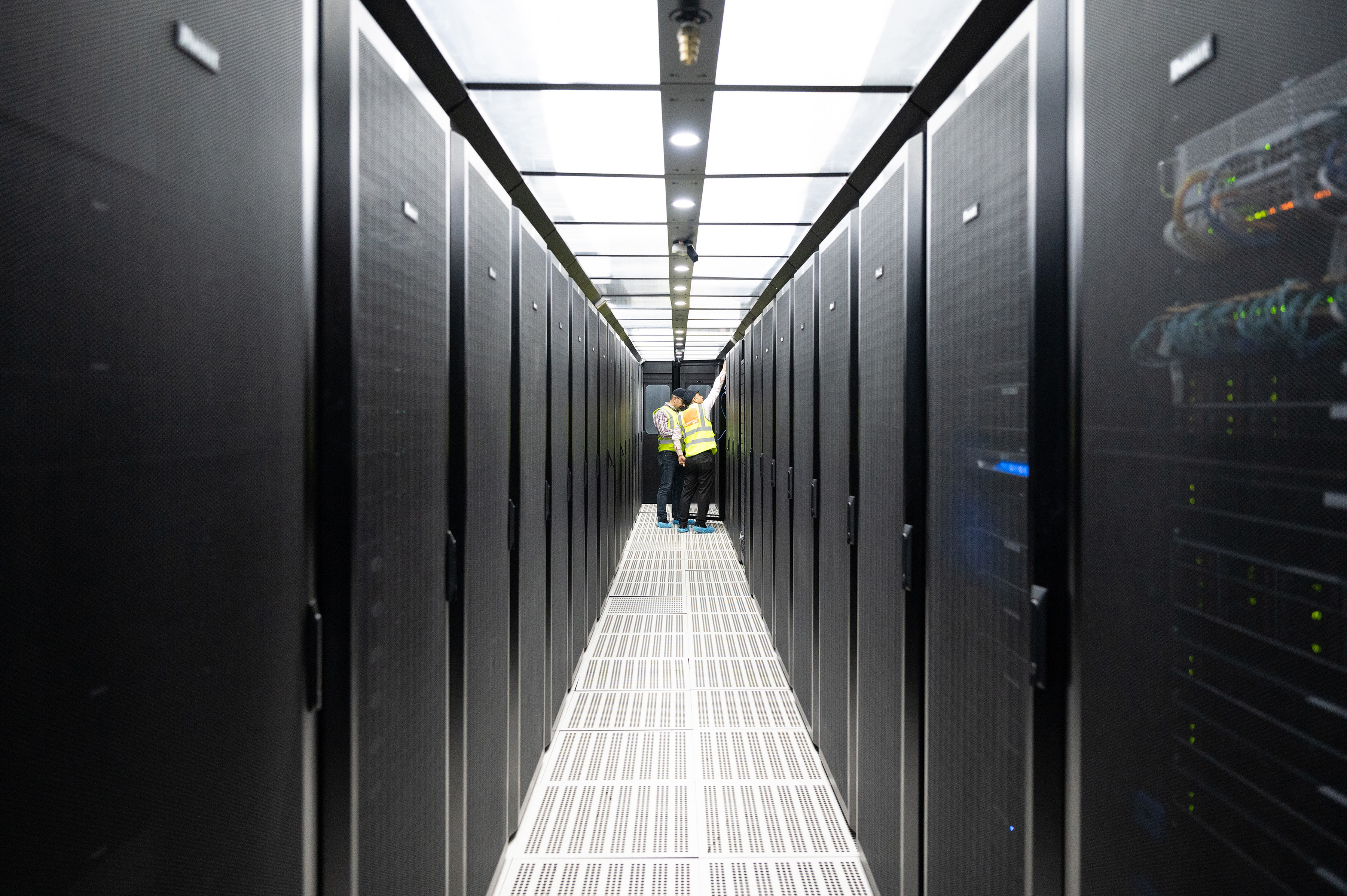 Orange technicians working in a data center