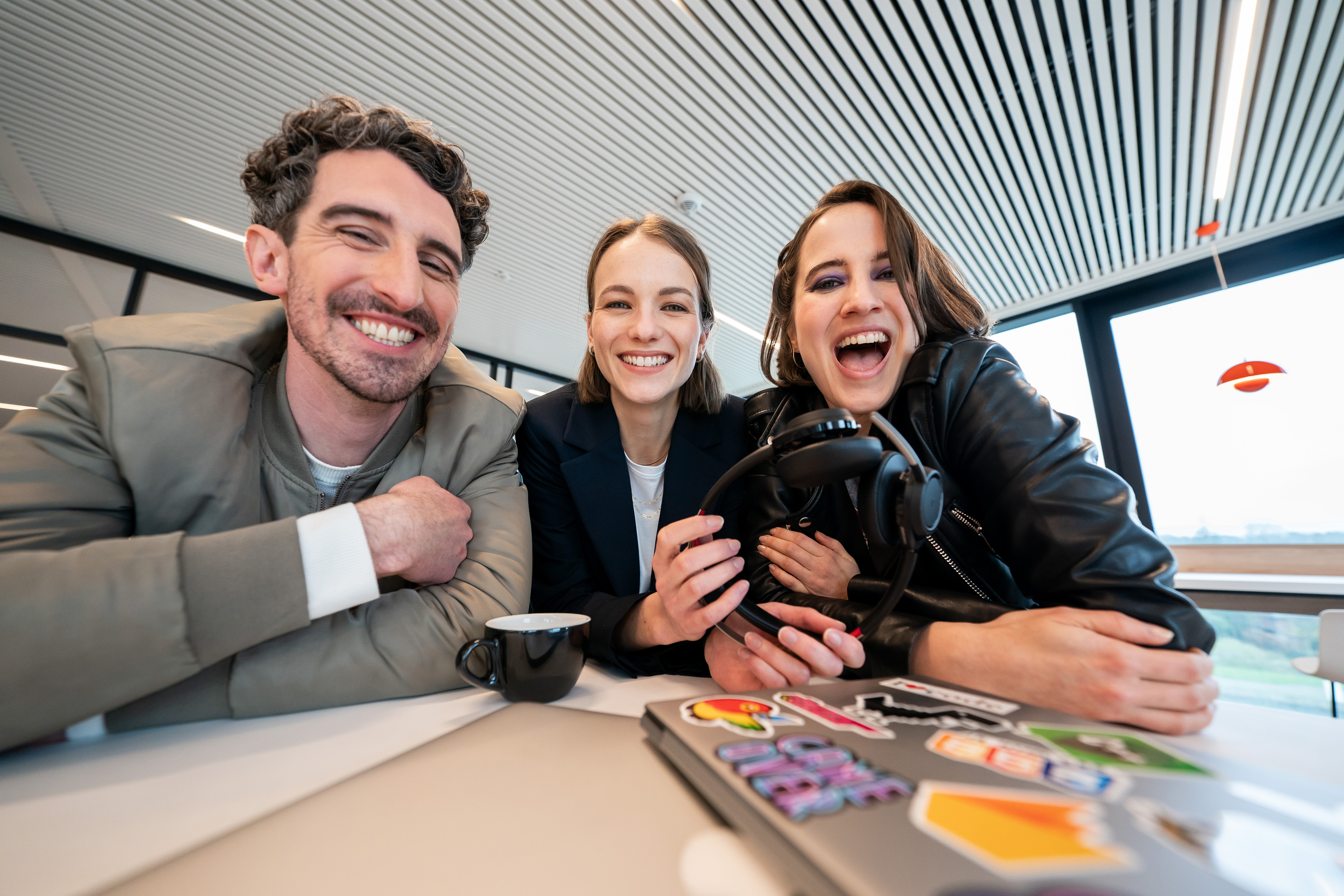 Smiling Orange team around a desk