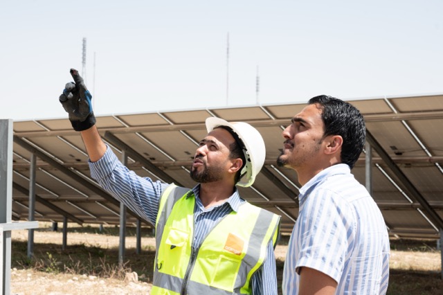 2 men working at a solar farm in Jordan