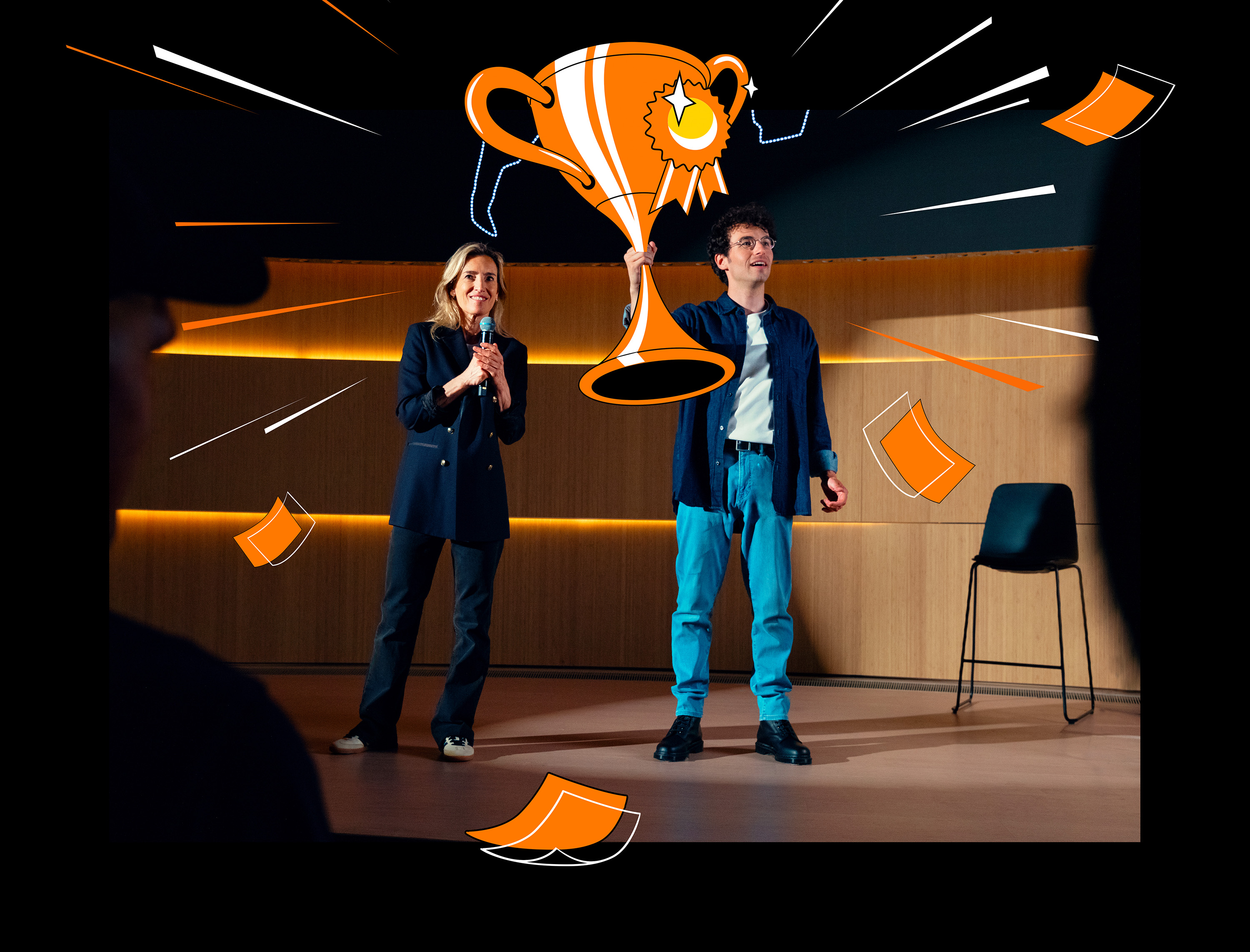Two Orange employees on stage with a drawn trophy in black version