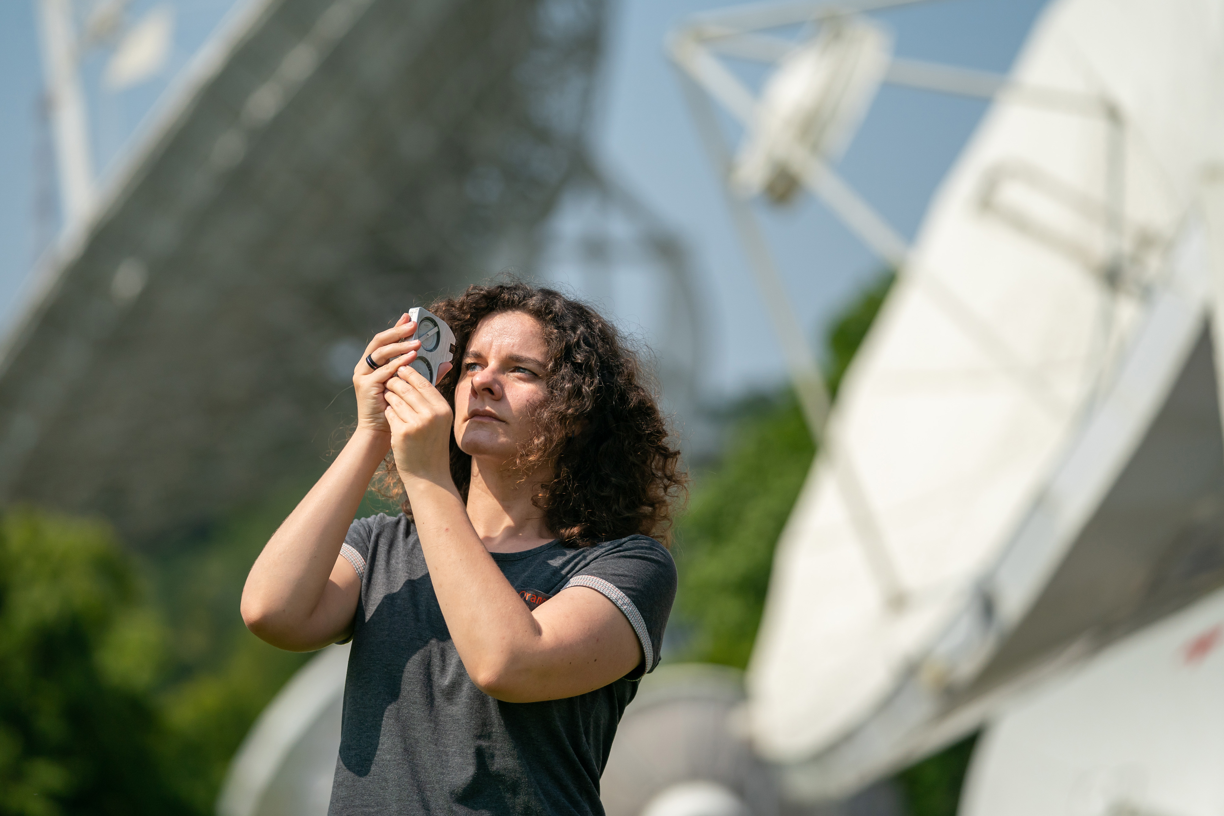 Orange engineer checking a satellite antenna