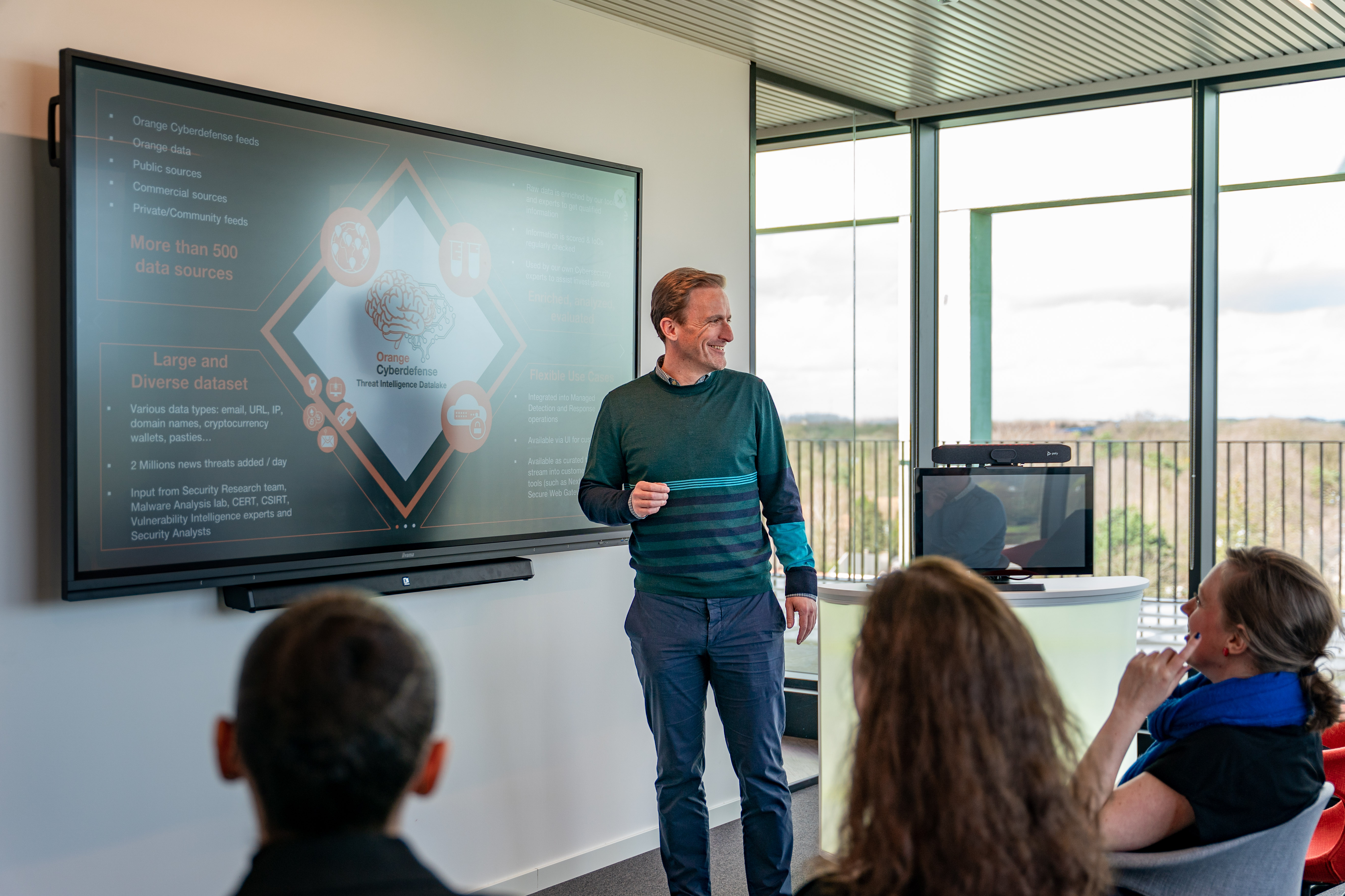 Orange manager presenting project on screen