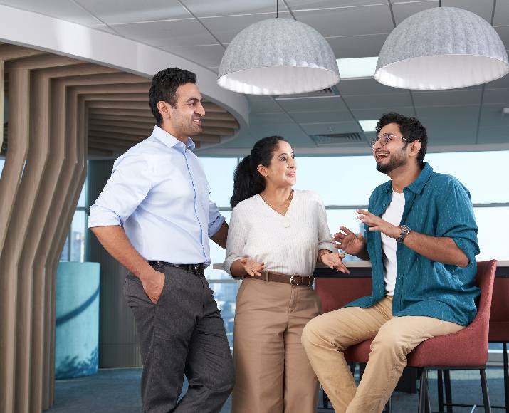 Orange employees gathered around a work table