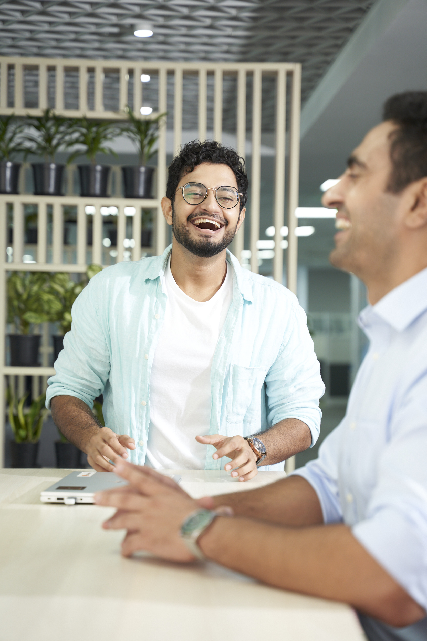 Two Orange employees talking with a smile