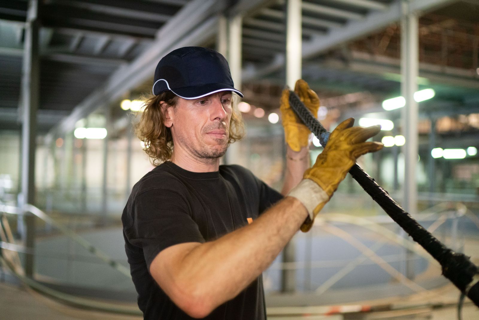 Orange technician handling a fiber optic cable
