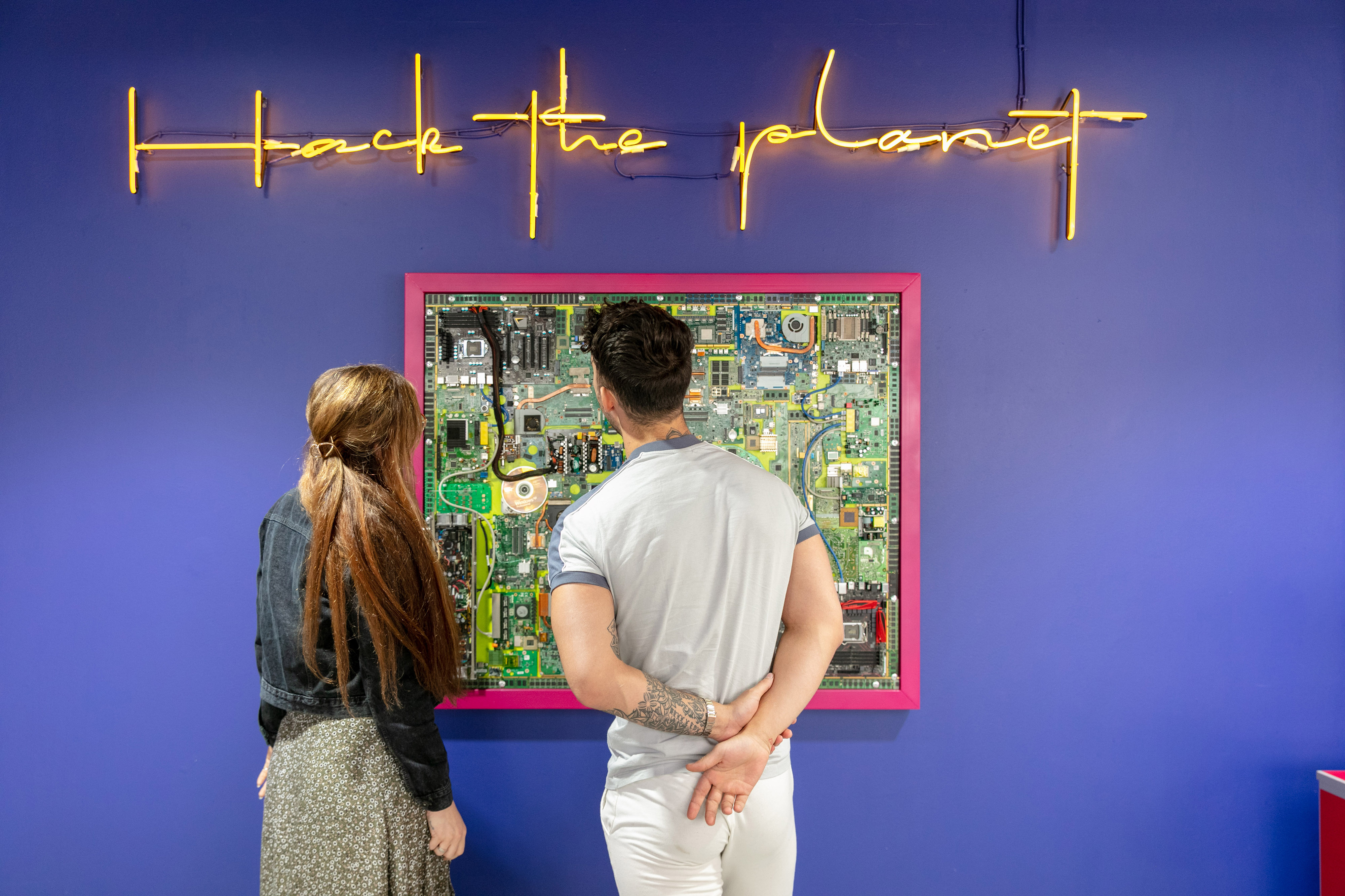 Visitors observing a tech exhibition at Orange