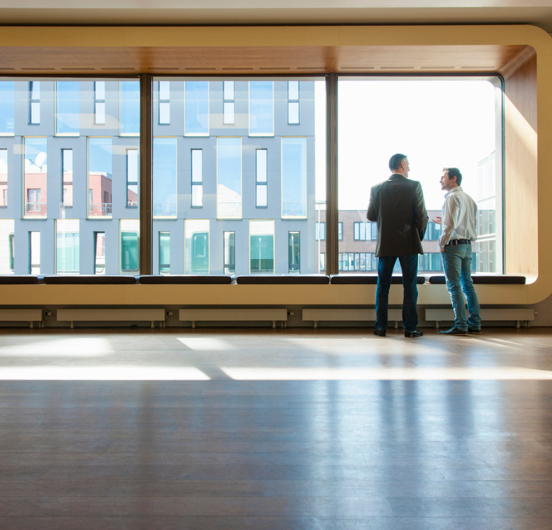 people in office looking at window