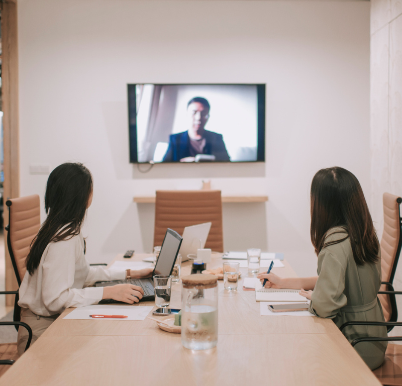 two people in office watching screen