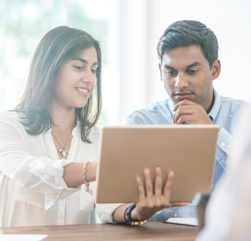 two people in meeting viewing tablet