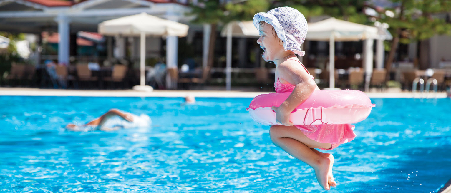 Child jumping into pool