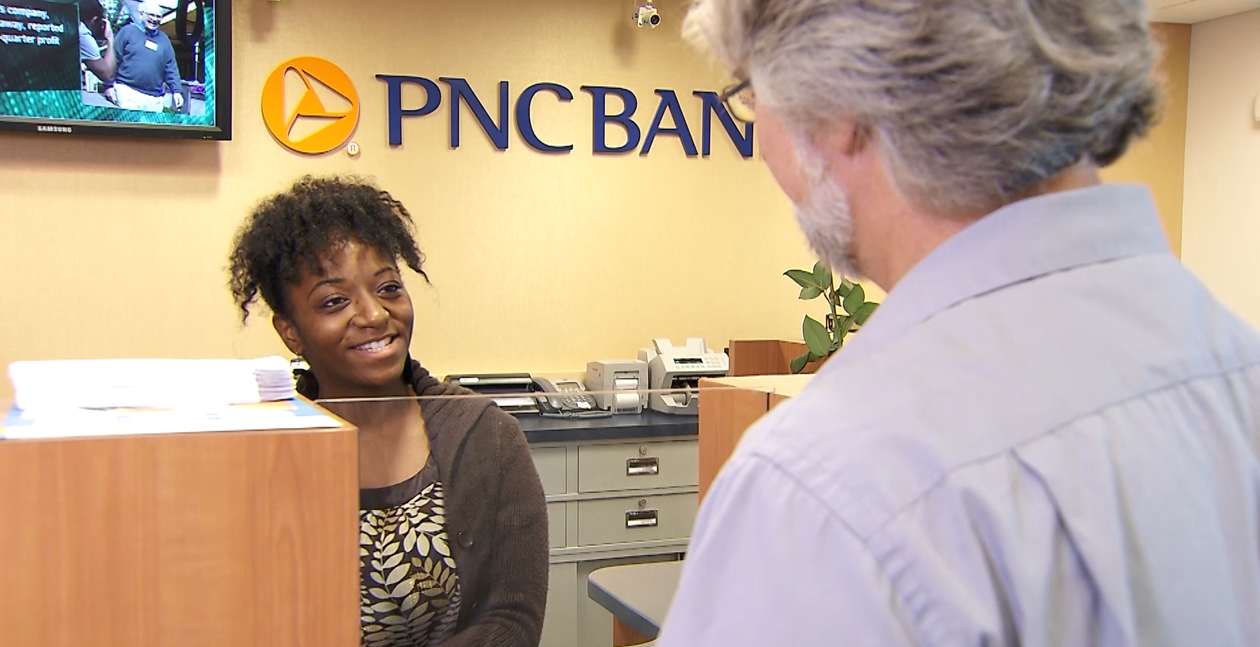 Teller greeting customer at a PNC Bank branch