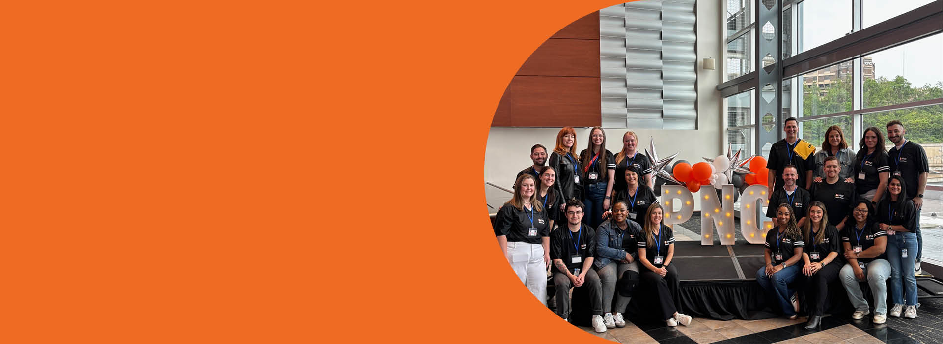A picture of the PNC Campus Recruiting team posing in front of light up letters that spell PNC.