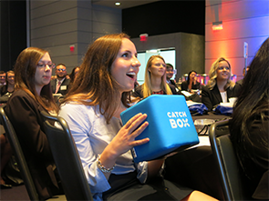 Collegiate woman asks question at event