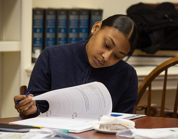 Female student reviews coursework in classroom 