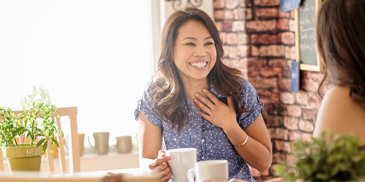 woman sitting enjoying a cup of coffee
