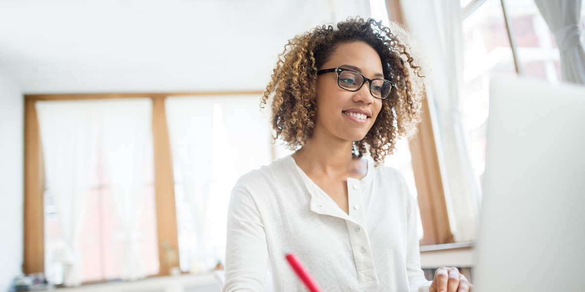 Woman working at laptop from home office