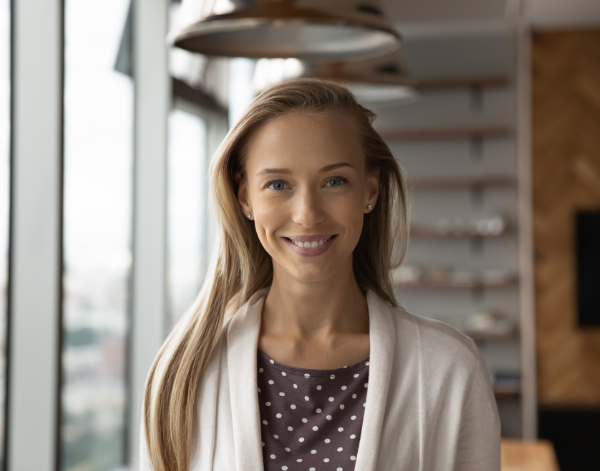 Headshot of a woman smiling in an office setting.