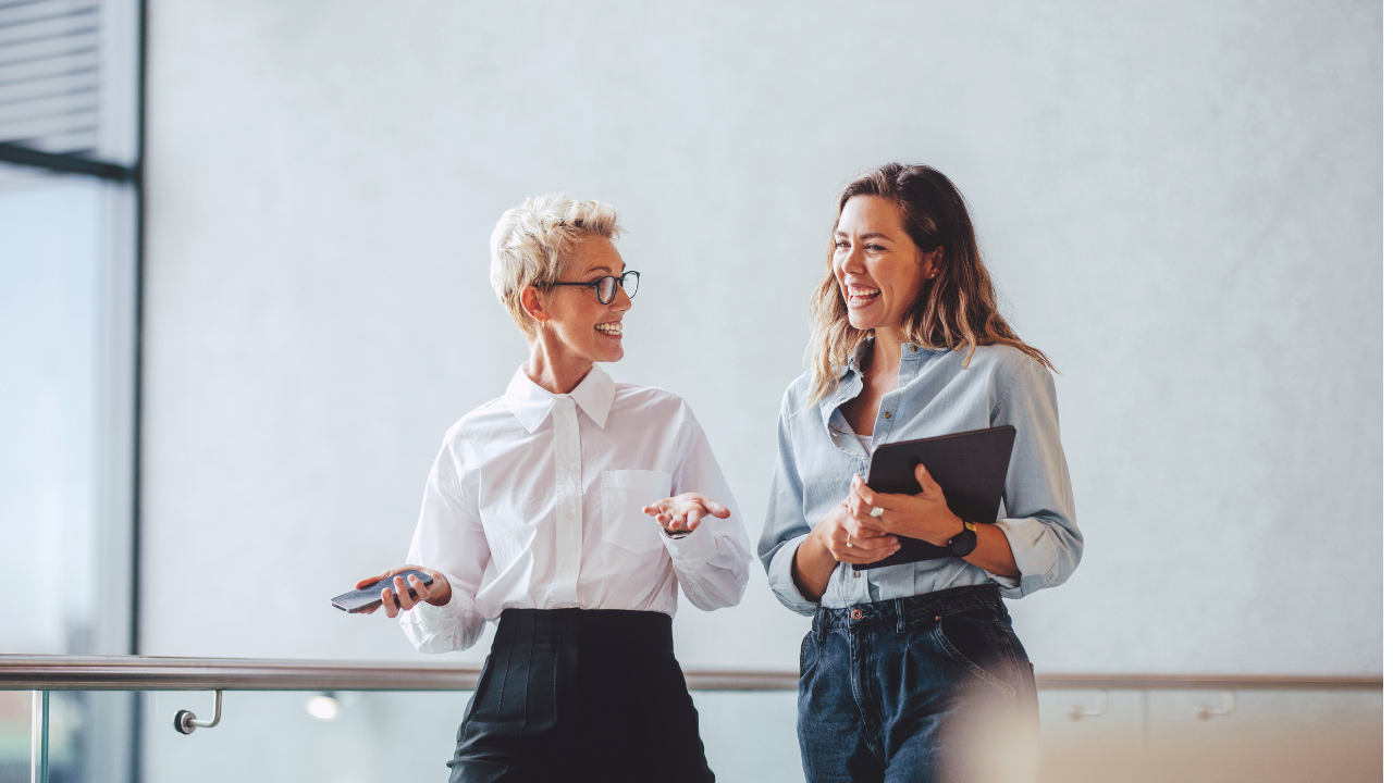 A student and a mentor walk down a hall