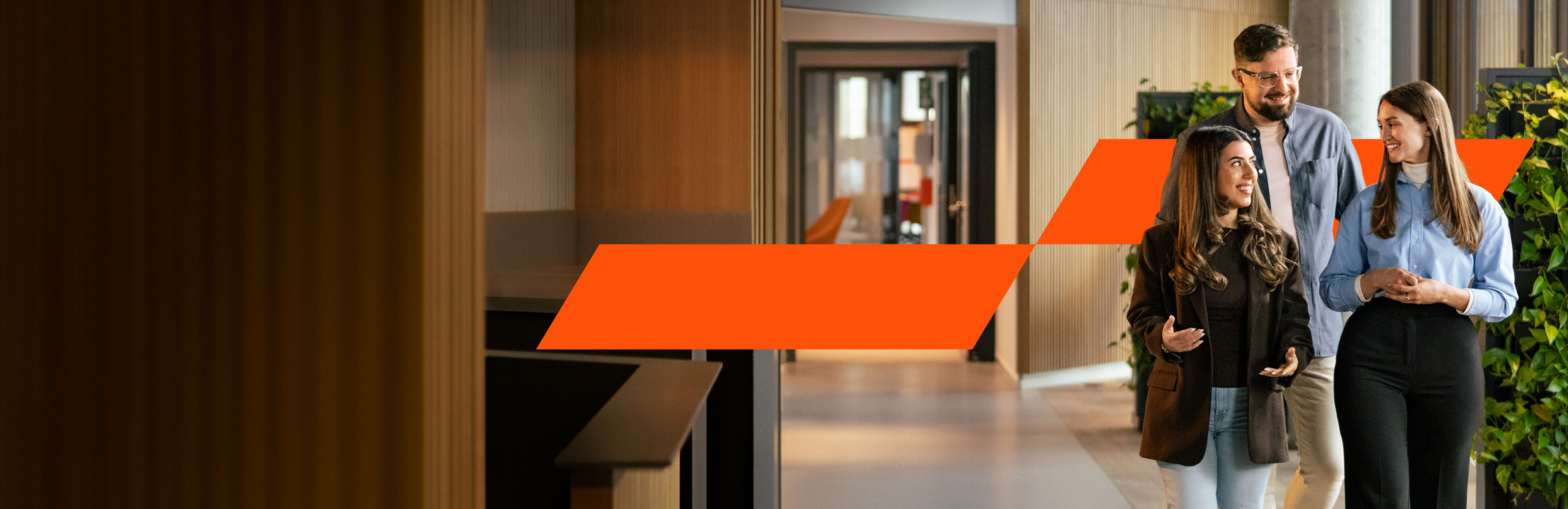 Colleagues walk through the office and laugh