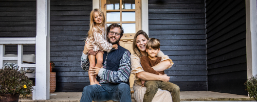 A family sitting on porch steps