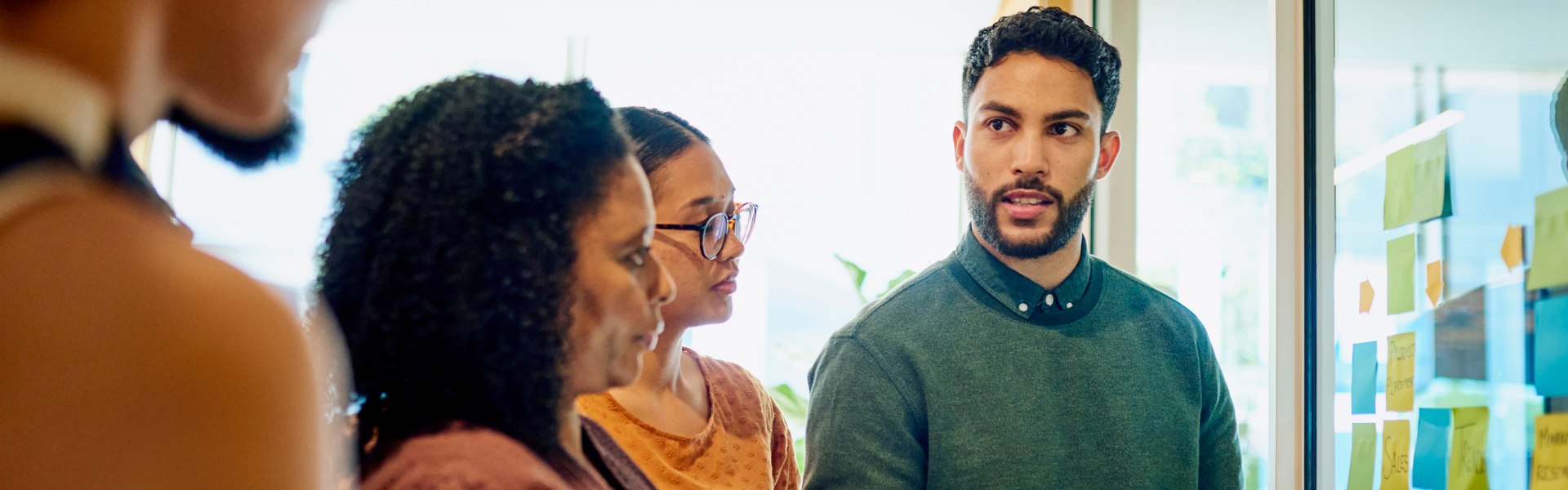 Diverse group brainstorm ideas in a modern office