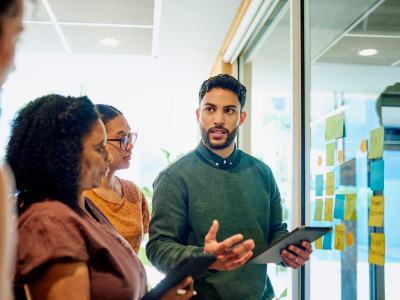 Diverse group brainstorm ideas in a modern office