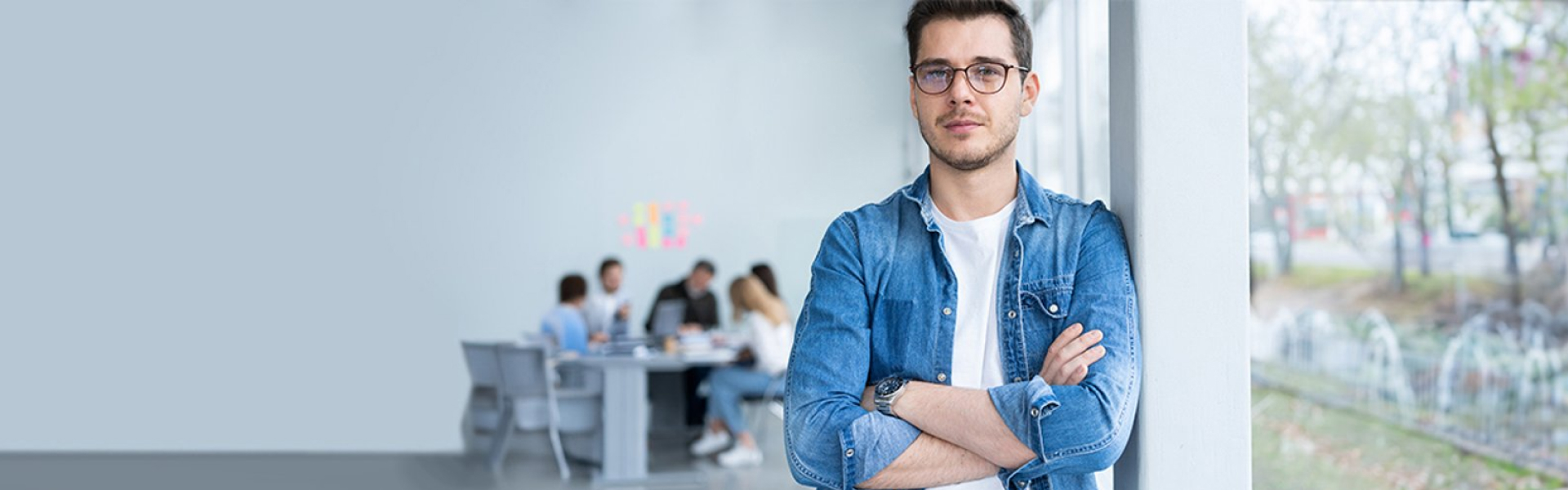 Graduate in a white t-shirt and denim jacket 