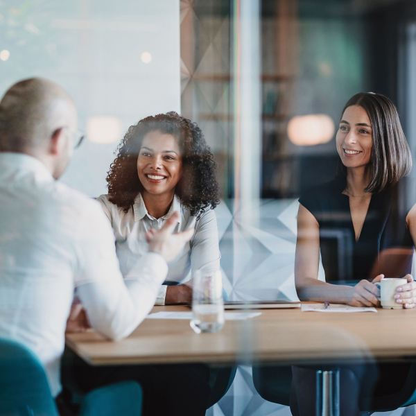 Group having a meeting behind a glass wall