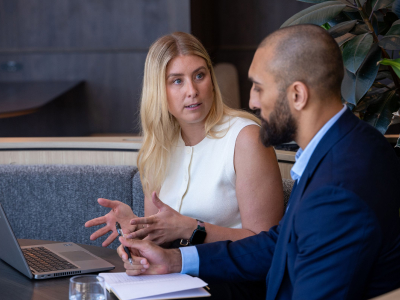 Man and woman talking at a round table