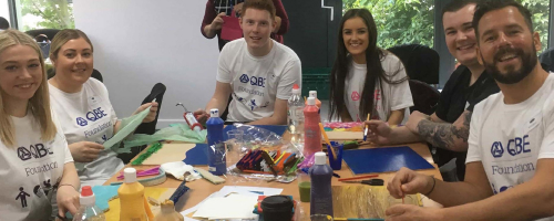 QBE team around a craft table
