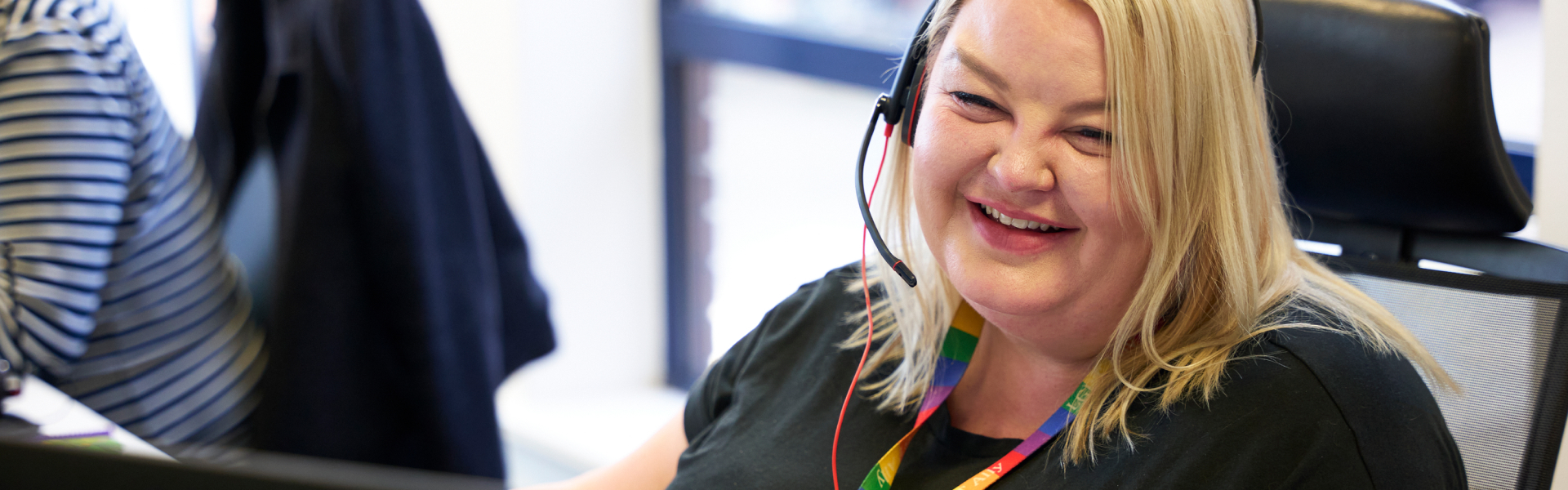 Smiling blonde lady wearing a headset