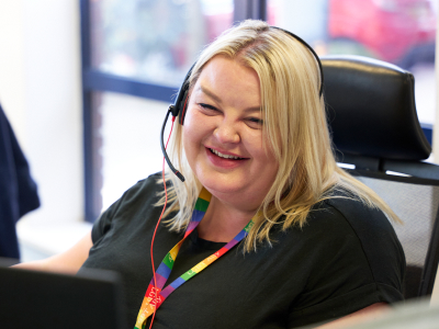 Smiling blonde lady wearing a headset