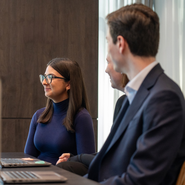 Three smartly dressed students at a desk
