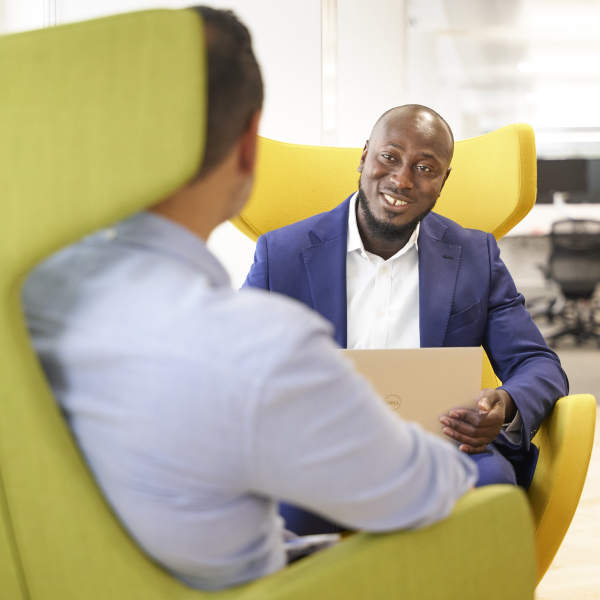 Two men sitting in yellow chairs