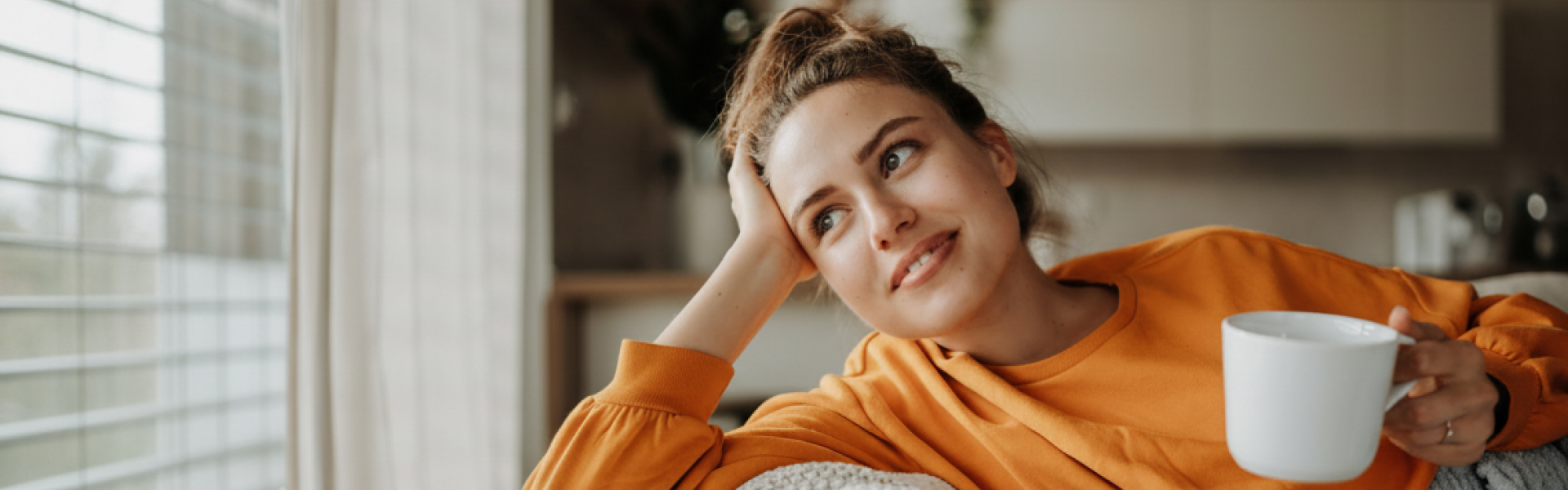 Woman on a couch with cup