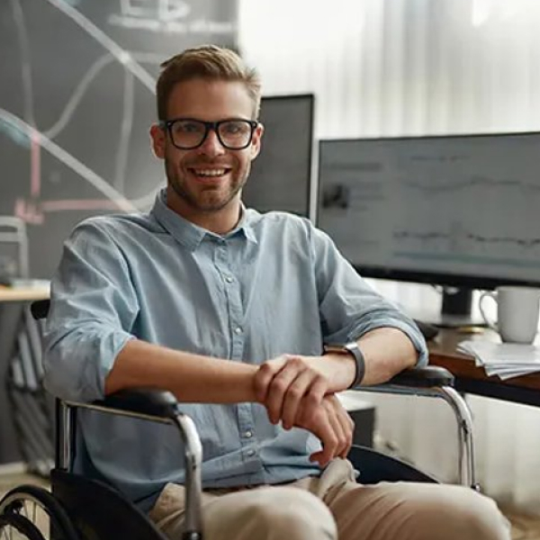 Young man in wheelchair infront of screen