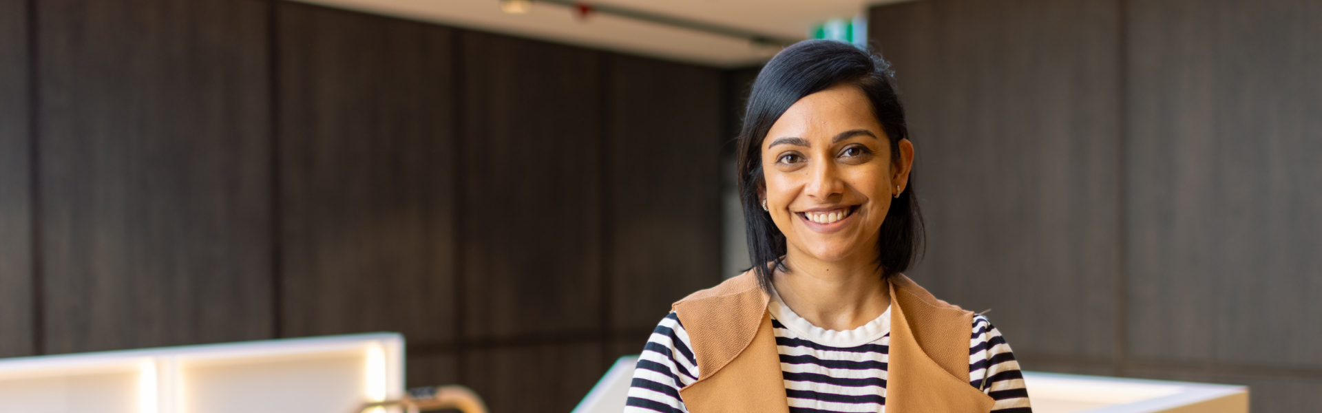 Young woman smiling in QBE office