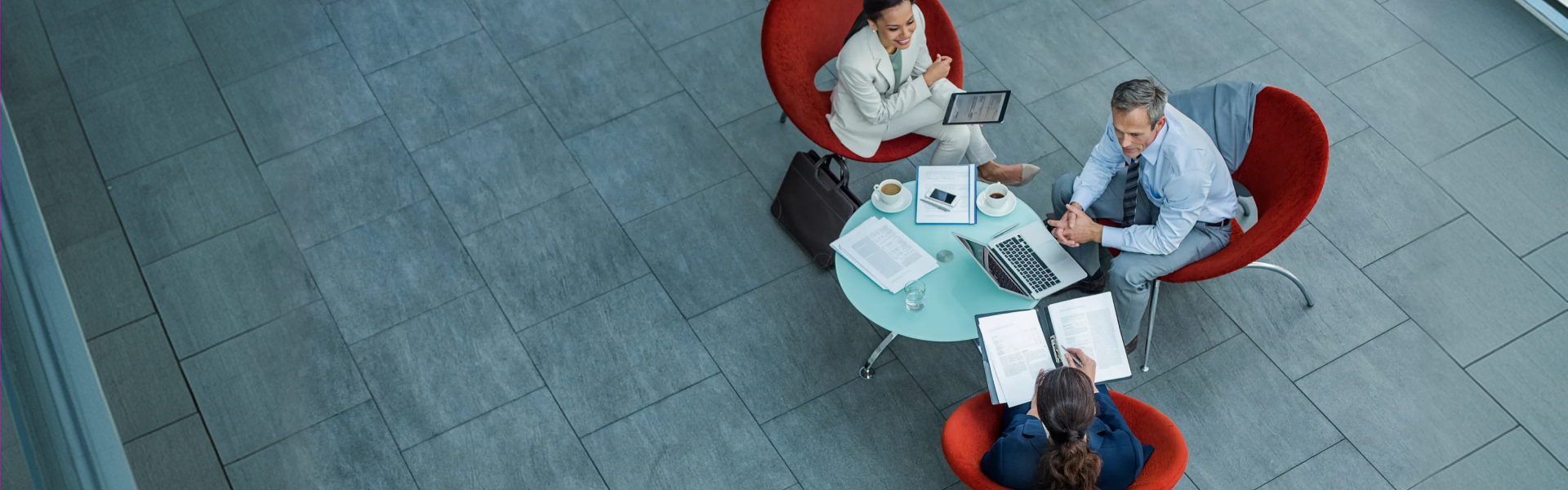Businesspeople discussing strategy at coffee table in office