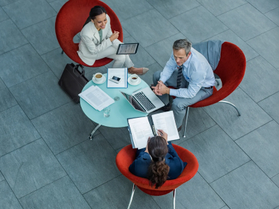 Businesspeople discussing strategy at coffee table in office